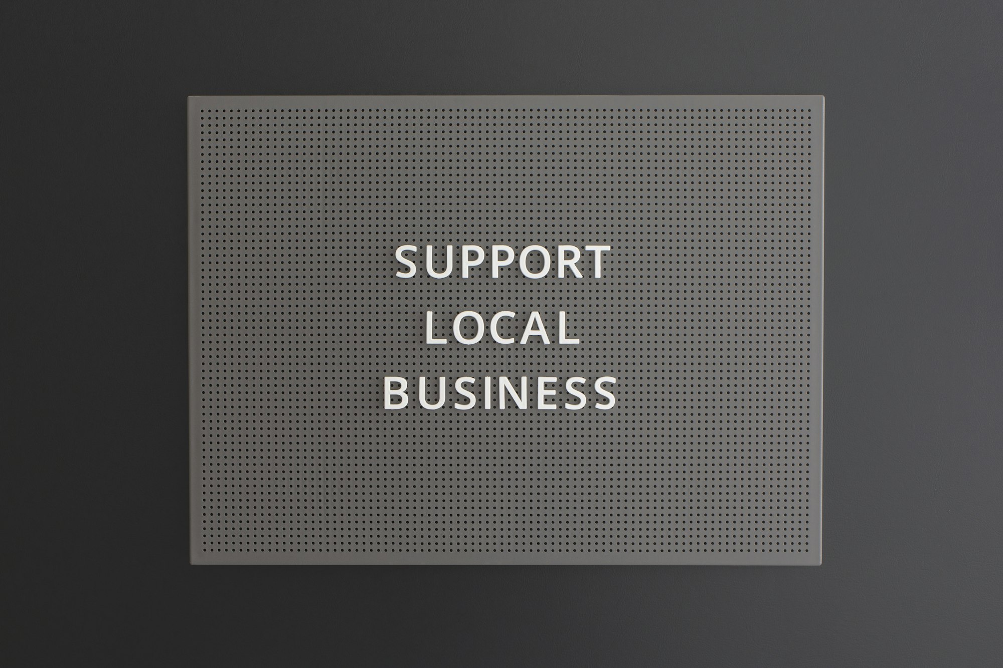 Support Local Business text written on blackboard on black background