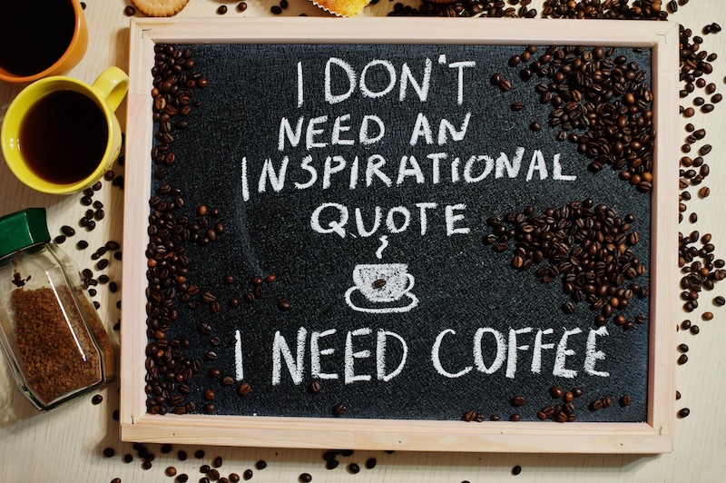 Coffee quote on chalkboard with beans